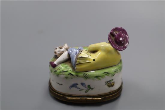 A Continental porcelain snuff box, modelled as a recumbent shepherd, height 6.5cm